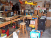 Drill press on right, battery station with shelf beneath bench top.